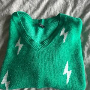 Dressed in LALA Green Sweater with White Lightning Bolts